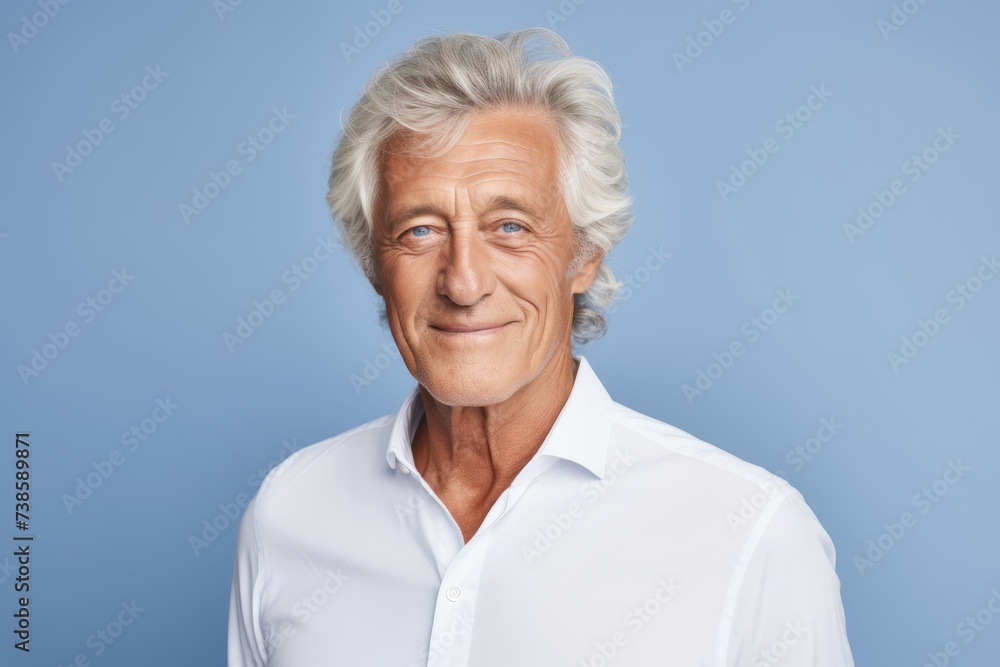 Handsome senior man in white shirt on a blue background. Handsome senior man in white shirt on a blue background.