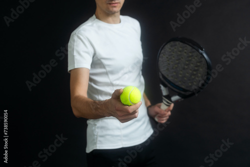 Padel Tennis Player with Racket in Hand. Paddle tennis, on a black background.  © Angelov