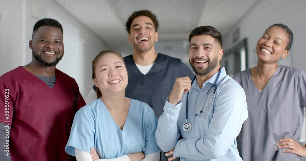 Diverse medical team smiling in a hospital corridor Diverse medical team smiling in a hospital corridor