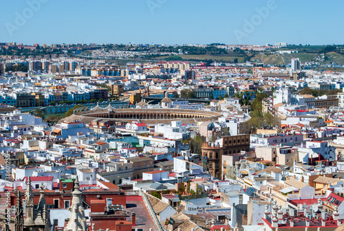view over the roofs of Seville with the Plaza de Toro of the Royal Maestranza of Seville in the background in Andalusia Seville