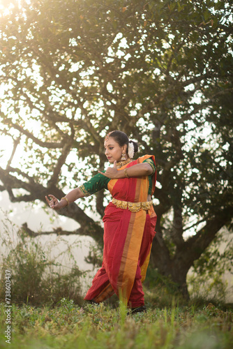 Female Indian Bharatanatyam dancer performing arts in various locations. 