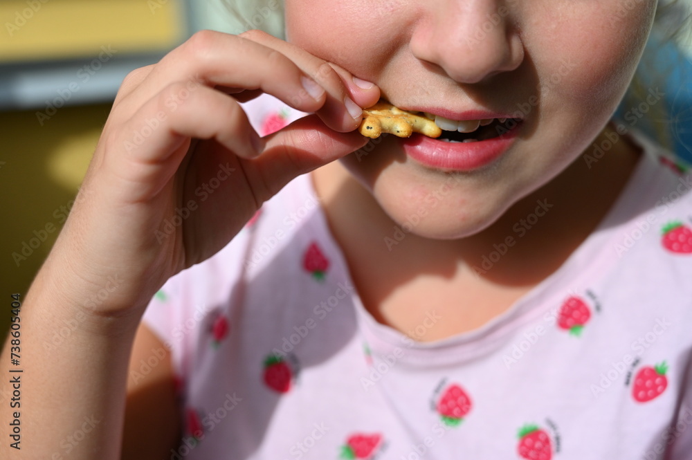 Young girl - child eating candy and sweets. Detail of face and mouth. Concept for healthy lifestyle - healthy - unhealthy sweet food and sugar. Young girl - child eating candy and sweets. Detail of face and mouth. Concept for healthy lifestyle - healthy - unhealthy sweet food and sugar.