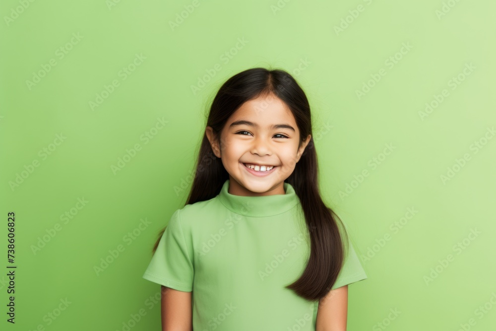 smiling little asian girl in green t-shirt on green background smiling little asian girl in green t-shirt on green background
