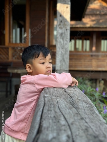 Smiling child sitting on a bench