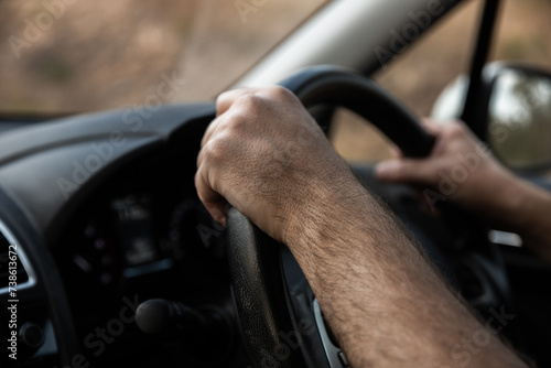 close up of driver hands on a steering wheel photo