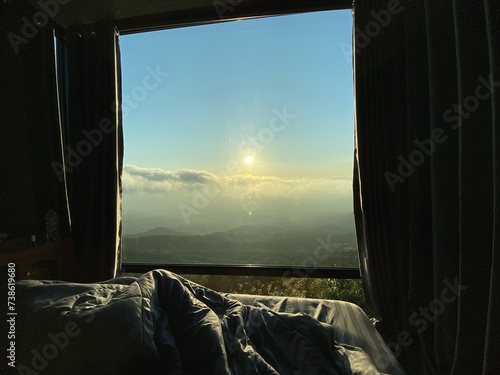 Morning View Through Wooden Window Overlooking Beach and Ocean Landscape with Open Sky and Sunlight Streaming into Bedroom
