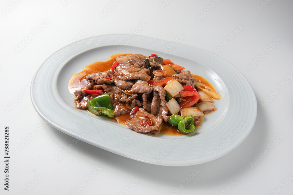 Chinese beef dish with vegetables isolated on white background 
