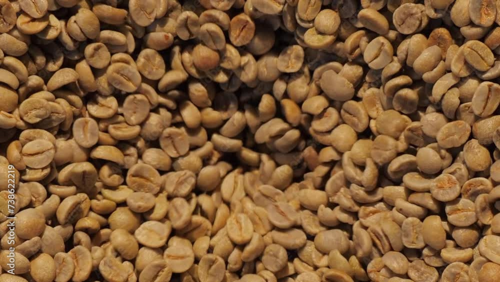 Production of fresh fried coffee. Beans falling into funnel. Preparation fresh caffeine on manufacturing warehouse. Coffee in large roaster falling beans. Coffee roaster machine mixing aroma beans Production of fresh fried coffee. Beans falling into funnel. Preparation fresh caffeine on manufacturing warehouse. Coffee in large roaster falling beans. Coffee roaster machine mixing aroma beans