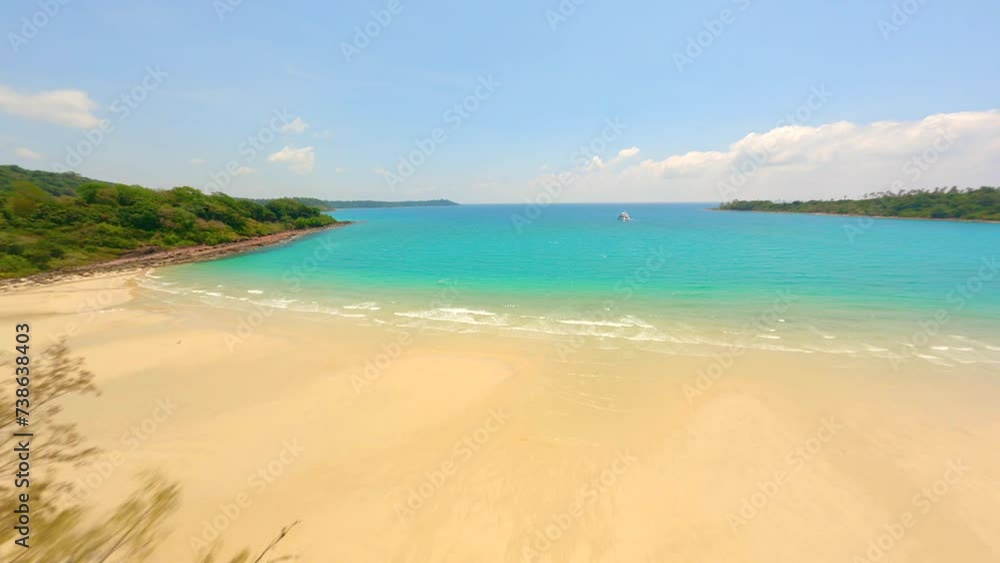 Dynamic FPV flight over tropical palms coastline and white sandy beach with turquoise water in Thailand. Dynamic FPV flight over tropical palms coastline and white sandy beach with turquoise water in Thailand.
