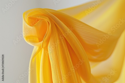 A close-up view of a vibrant yellow piece of fabric. Versatile and eye-catching, this image can be used for various creative projects