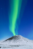 Aurora borealis on the Lofoten islands, Norway. Northern Lights over the mountains. Scandinavia. Night sky with polar lights. Landscape in the north in winter time.