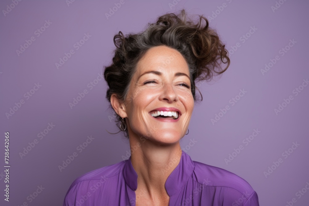Portrait of a beautiful middle aged woman smiling against purple background. Portrait of a beautiful middle aged woman smiling against purple background.