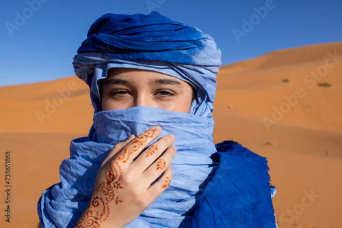 Young woman with blue turban in the desert photo