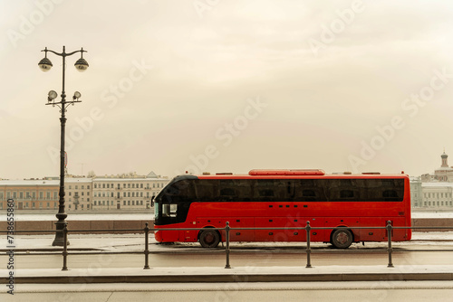 a tourist bus awaits tourists on the Neva River embankment