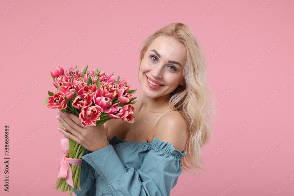 Happy young woman with beautiful bouquet on dusty pink background Happy young woman with beautiful bouquet on dusty pink background