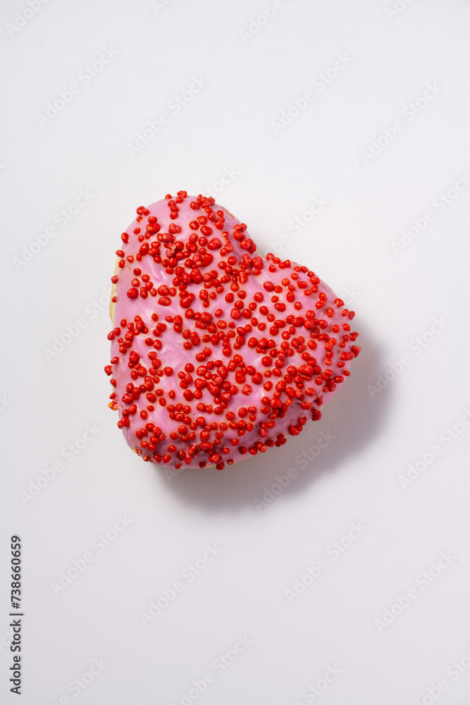 Fototapeta premium Heart shaped donut with glaze on white background