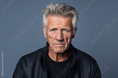 Portrait of a senior man with grey hair. Studio shot. © Loli