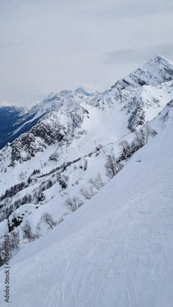 Aerial view of the snowy peaks of the Rocky mountains range. Winter snowy natural landscape. Aerial view of the snowy peaks of the Rocky mountains range. Winter snowy natural landscape.