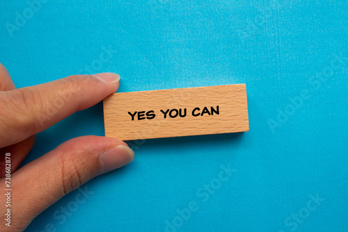 Yes you can words written on wooden block with blue background. Conceptual symbol. Top view, copy space.