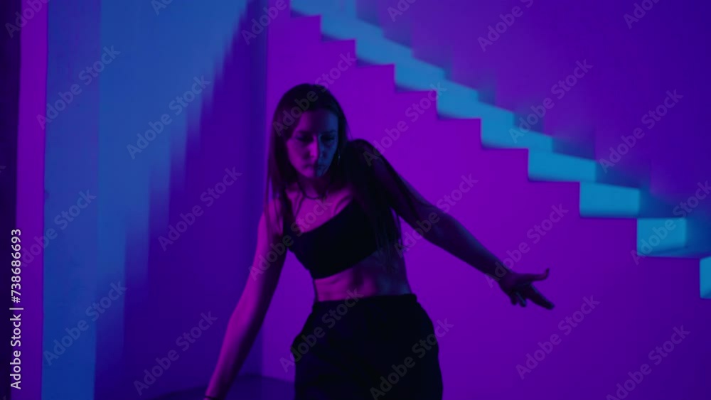 Female Hip-Hop Dancer Moving Emotionally In Studio With Neon Lights, Full-Length Portrait Female Hip-Hop Dancer Moving Emotionally In Studio With Neon Lights, Full-Length Portrait