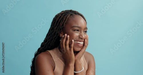 Happy, black woman and laughing with fashion for funny joke, humor or comedy on a blue studio background. African female person or model with smile, jewelry or style in satisfaction on mockup space photo