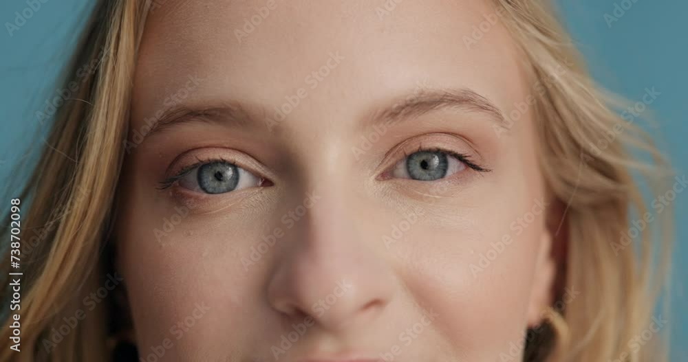 Woman, vision and face with closeup of eyes for optometry, glaucoma exam and optical assessment in studio. Ophthalmology, person and portrait for eyecare, eyesight and wellness on blue background Woman, vision and face with closeup of eyes for optometry, glaucoma exam and optical assessment in studio. Ophthalmology, person and portrait for eyecare, eyesight and wellness on blue background