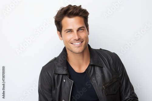 Portrait of handsome young man in black leather jacket on white background