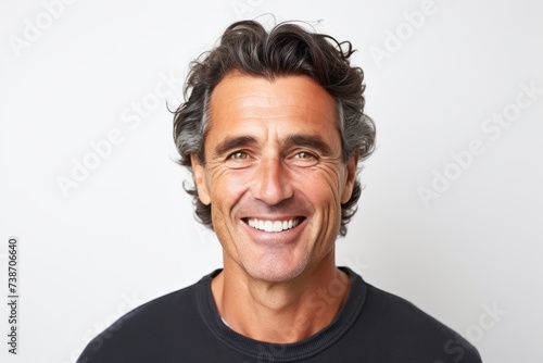 Portrait of a handsome middle-aged man smiling against white background