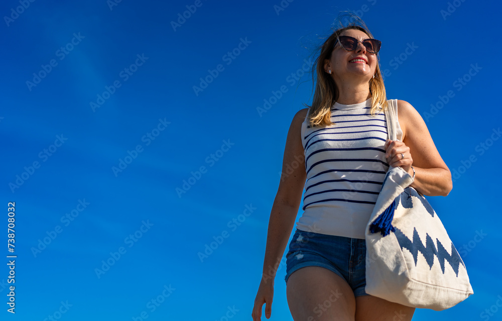 Beautiful mid adult woman walking on sunny beach
Beautiful mid adult woman walking on sunny beach