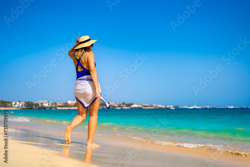 Beautiful woman walking on sunny beach Santa Maria, Sal Island, Cape Verde  © Jacek Chabraszewski