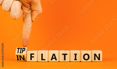 Inflation or tipflation symbol. Concept words Inflation Tipflation on beautiful wooden blocks. Beautiful orange background. Businessman hand. Business inflation Tipflation concept. Copy space photo