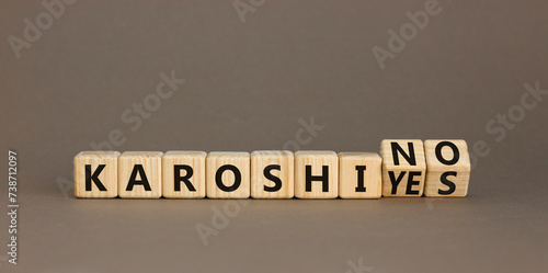 Karoshi yes or no symbol. Concept words Karoshi Yes or No on beautiful wooden blocks. Beautiful grey table grey background. Business and stop karoshi concept. Copy space.