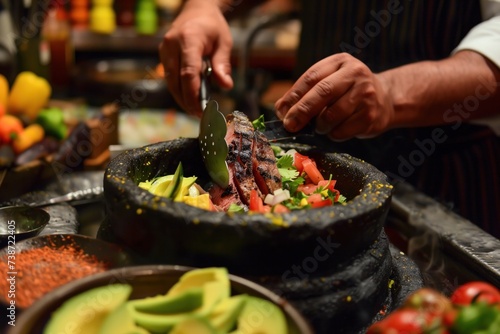 A chef's hands expertly prepare a traditional molcajete dish with grilled meat and fresh salsa, showcasing the rich culinary traditions of Mexican cuisine photo