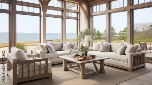 Coastal design. family room with neutral wood beams and swivel chairs around coffee table