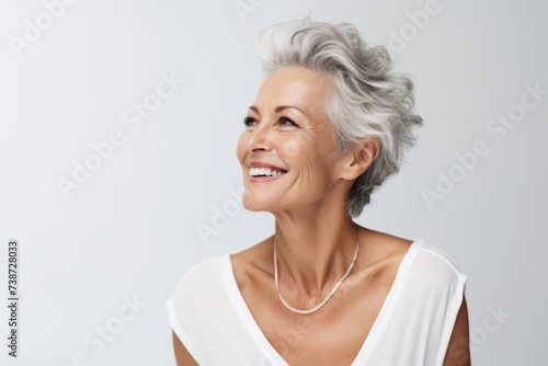 Close up portrait of happy mature woman with grey hair and beautiful smile