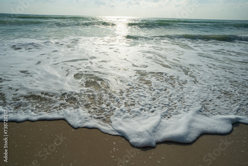 Sea beach wave splash on sand beach sunrise relax summer vacation