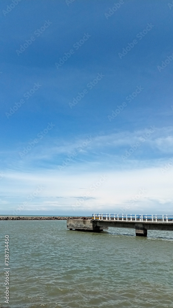 old bridge over the sea with bright sky color