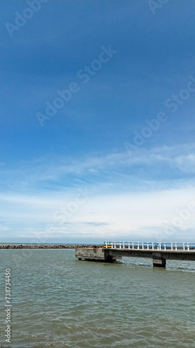 old bridge over the sea with bright sky color © M.Fauzi