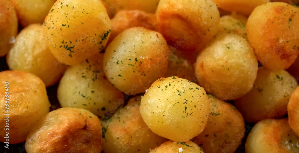 Roasted potato background. Homemade cooking fresh baked potato pattern, serving food for restaurant, menu, advert or package, close up, selective focus Roasted potato background. Homemade cooking fresh baked potato pattern, serving food for restaurant, menu, advert or package, close up, selective focus