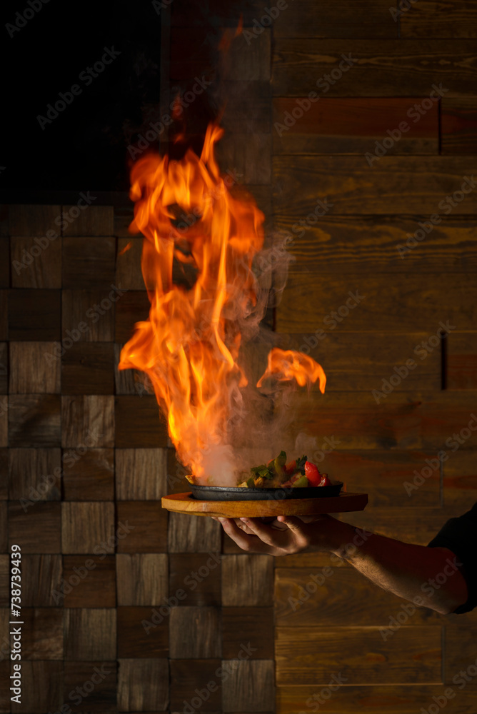 Obraz premium fajitas set on fire on a plate