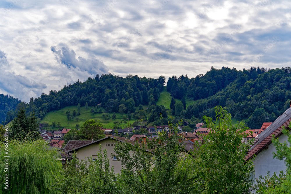 Scenic landscape with traditional houses at Slovenian City of Skofja Loka on a cloudy summer day. Photo taken August 9th, 2023, Škofja Loka, Slovenia.