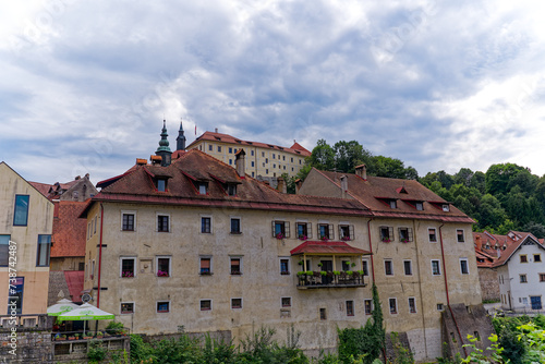 Old town with historic houses and castle on a hill at Slovenian City of Skofja Loka on a cloudy summer day. Photo taken August 9th, 2023, Skofja Loka, Slovenia.