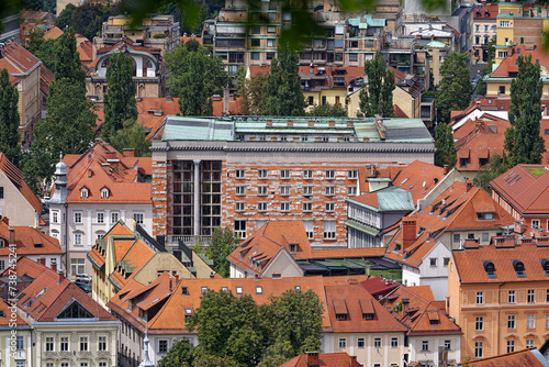 Aerial view of Slovenian City of Ljubljana seen from viewpoint of castle hill on a cloudy summer day. Photo taken August 9th, 2023, Ljubljana, Slovenia.