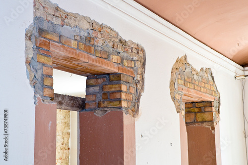 New reinforced brick lintel useful for creating a new door, or a new window, in an old stone and brick wall in a construction site