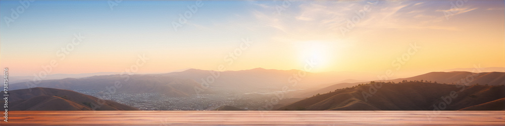 Wooden table with a beautiful sunset and mountain landscape in the background