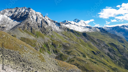 Idyllic hiking trail with panoramic view of snow capped majestic mountain peak Hochalmspitze in High Tauern National Park, Carinthia, Austria. Wanderlust in Austrian Alps. Nature escape. Exploration