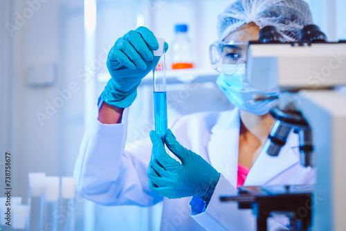 Female scientist diligently conducts virus blood lab tests  contributing to critical research and advancements in the field of virology.