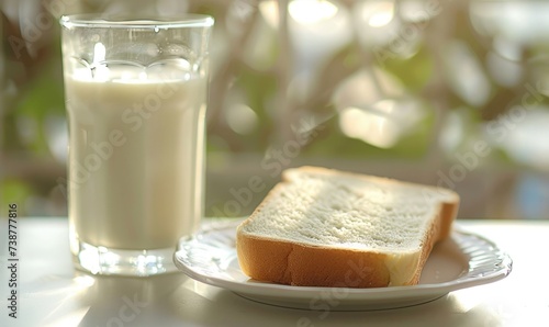 a slice of white bread on a plate, a glass of whole milk, both on the breakfast table, 