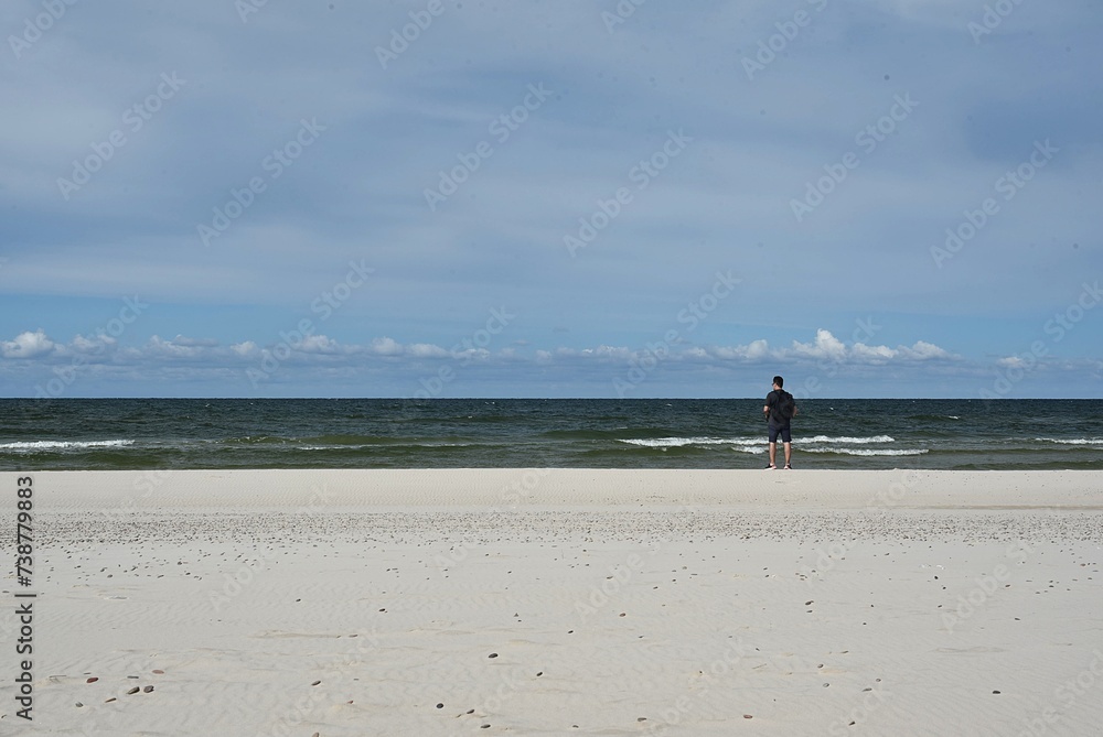 a man walking on the coast of the Baltic Sea