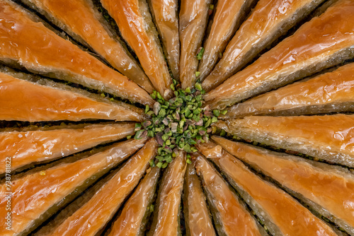 Close up top view of carrot slice baklava on a tray isolated on white background.